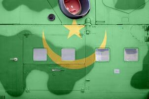 Mauritania flag depicted on side part of military armored helicopter closeup. Army forces aircraft conceptual background photo