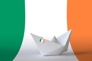 Ireland flag depicted on paper origami ship closeup. Handmade arts concept photo