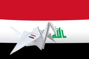 Iraq flag depicted on paper origami crane wing. Handmade arts concept photo