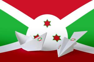 Burundi flag depicted on paper origami airplane and boat. Handmade arts concept photo