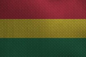 Bolivia flag depicted in paint colors on old brushed metal plate or wall closeup. Textured banner on rough background photo