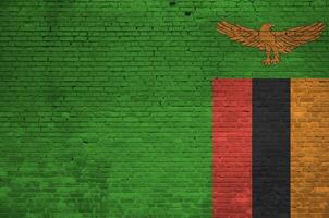 Zambia flag depicted in paint colors on old brick wall. Textured banner on big brick wall masonry background photo