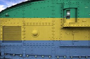 Gabon flag depicted on side part of military armored tank closeup. Army forces conceptual background photo