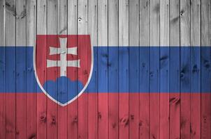 Slovakia flag depicted in bright paint colors on old wooden wall. Textured banner on rough background photo