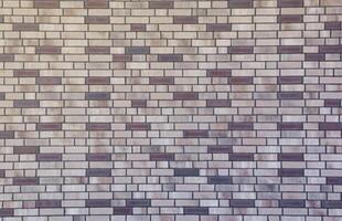 Dark brick wall pattern with chaotic masonry order. Background texture or resource for 3d texturing. Many bricks in big modern stone wall photo