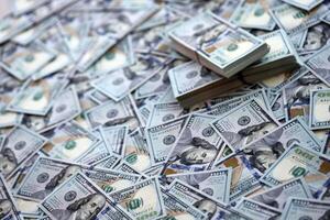Very big amount of US hundred dollar bills. Huge quantity of united states currency notes on flat table photo