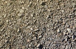 Background of shattered stony stones surface in mountain area. Texture with natural light photo