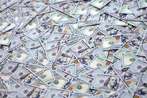 Very big amount of US hundred dollar bills. Huge quantity of united states currency notes on flat table photo