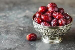 AI generated Raw date fruit ready to eat in silver bowl on concrete background. Traditional, delicious and healthy ramadan food photo