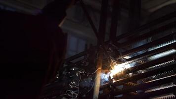 Welder working on construction site with metal reinforcement video