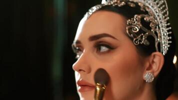 Close-up of a woman with a tiara, focus on the sparkling crown with a blurred background. video