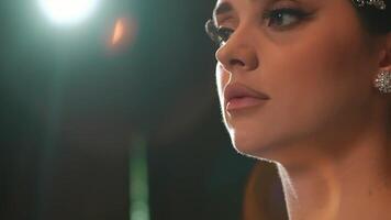 Close-up of a woman's lower face and neck with soft lighting, highlighting her lips and jawline. video