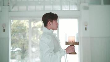 Waiter serving drinks on a tray in a bright, modern restaurant setting. video