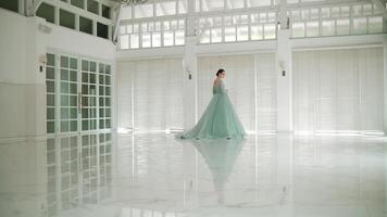 elegante bailarina dançando dentro uma brilhante, espaçoso corredor com ampla janelas e reflexivo chão. video