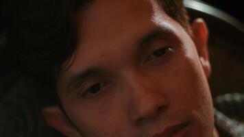 Close-up of a young man with a pensive expression, shallow depth of field. video