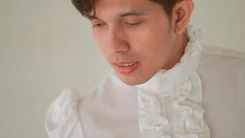 Close-up of a pensive young man with a blurred background, expressing contemplation or sadness. video