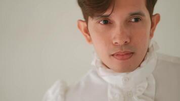 Close-up of a pensive young man with a blurred background, expressing contemplation or sadness. video