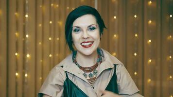 Portrait of a beautiful successful woman smiling. Caucasian business woman smiling, talking and looking at the camera against a background of yellow flashing lights. video