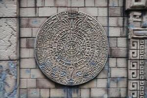 Ancient Mayan Calendar or Aztec calendar with rough relief surface photo