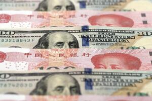 Many money bills of People Republic of China and United States. PRC Yuan and USD dollars photo