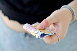 Woman hand with indian rupees bills. Concept of financial operations in cash in India photo