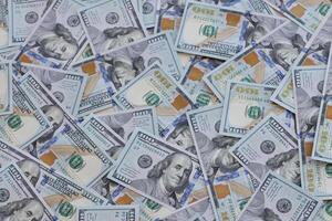Very big amount of US hundred dollar bills. Huge quantity of united states currency notes on flat table photo