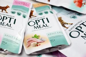 KHARKIV, UKRAINE - JANUARY 2, 2021 Optimeal cat meal packs. Optimeal is product by Kormotech LLC, a global family company, the largest producer of pet food in Ukraine photo