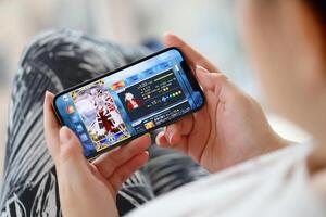 Fate Grand Order mobile iOS game on iPhone 15 smartphone screen in female hands during mobile gameplay photo