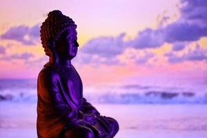 Buddha Purnima and Vesak day concept, Buddha statue with low key light against beautiful and colorful background. Meditation photo