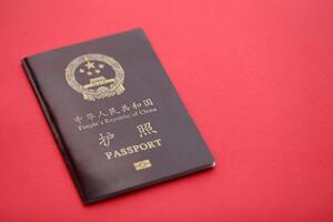 Red passport of People Republic of China. PRC chinese passport on bright background photo