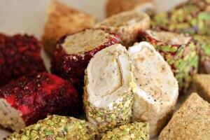 Many rolls of turkish delight with different flavors and fillings close up on table. Cutted Turk Lokumu photo