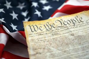 Preamble to the Constitution of the United States and American Flag close up photo