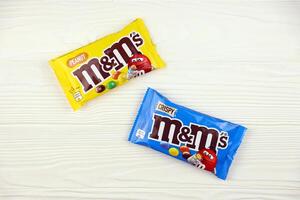KHARKIV, UKRAINE - JANUARY 2, 2021 M and Ms colorful button shaped chocolate candies. Multi colored chocolates each of which has the letter m printed in lower case in white photo