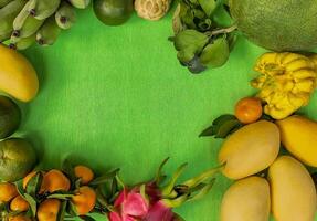 Tropical Fruit Assortment on Green Backdrop photo