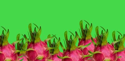 Red Dragon Fruits on Green Background with Copy Space photo