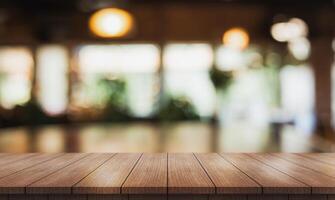 AI generated Empty wooden table top with lights bokeh on blur restaurant background. photo