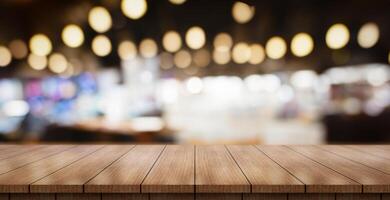 AI generated Empty wooden table top with lights bokeh on blur restaurant background. photo