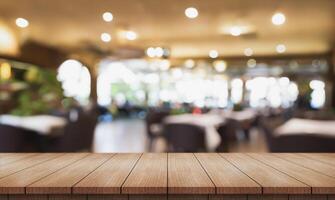 AI generated Empty wooden table top with lights bokeh on blur restaurant background. photo