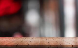 Empty wooden table top with lights bokeh on blur restaurant background photo