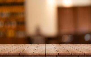 Empty wooden table top with lights bokeh on blur restaurant background photo