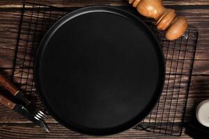 Black plate on a wooden table. photo