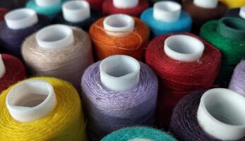 colorful spools of thread for embroidery close up background photo