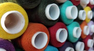 colorful spools of thread for embroidery close up background photo