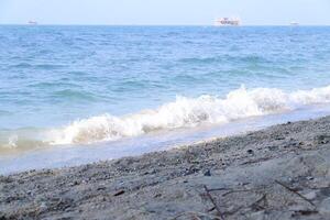 Beach and sea. Sea waves beat against the sandy shore. photo