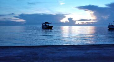 Fishing boat in the sea at sunset photo