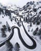 AI generated Aerial view of winding road in mountains with snow photo