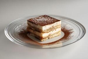 AI generated Tiramisu cake on a glass plate on a wooden table photo