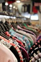 A row of clothes hanging on a rack in a store. Suitable for fashion and retail concepts photo