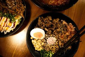 Japanese ramen, chopsticks, egg in bowl, traditional cuisine served, noodles, meat in close-up view, hot soup filled with toppings, photo