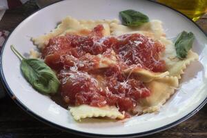 Side  view of  Ravioli dinner on natural wood surface photo